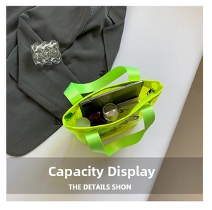 Detail of neon green transparent PVC tote bag showing large capacity for tablet and phone