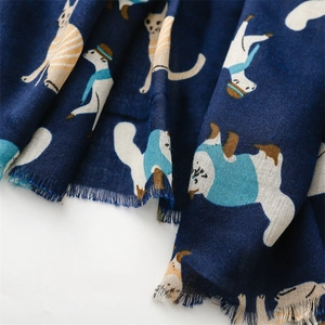 Close-up of soft navy blue scarf with fashion cat illustrations and fringe edges