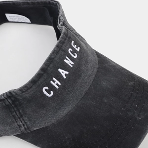 Detailed close-up view of vintage washed denim sun visor with CHANCE embroidery