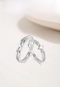 Detail of S925 sterling silver couple rings with woven texture and zircon star accents