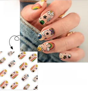 Close-up of cute cartoon graffiti press-on nails featuring rainbow and sun patterns