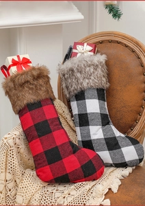 Plaid Christmas stockings with faux fur trim displayed on a cozy vintage leather chair