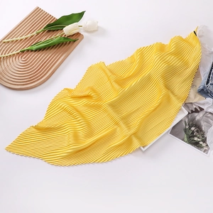 Elegant 70cm yellow pleated silk scarf for women displayed with tulip floral props