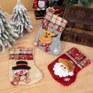 Set of 3 Christmas stockings with Santa Claus Snowman and Reindeer on rustic wood table