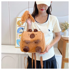 Cute brown plush Capybara crossbody bag shown on a model in a cozy indoor setting
