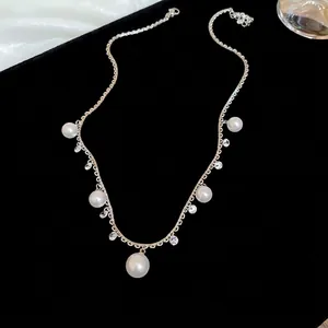 Elegant gold pearl tassel necklace with zirconia accents on a black velvet background