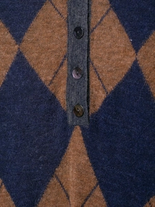 Close-up of knit diamond pattern and buttons on vintage polo shirt for men