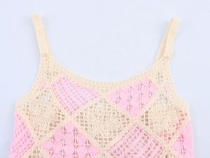 Detail of crochet knit vest showing pink and beige diamond hollow flower patterns