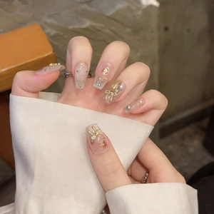 Handmade press-on nails with rose pattern, gold 3D bows, and delicate pearl accents