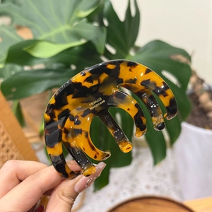 Close-up of a large tortoiseshell acetate claw clip with FRANCE Handmade engraving