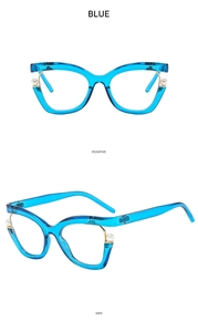 Detail view of transparent blue cat-eye glasses frame with elegant side pearl accents