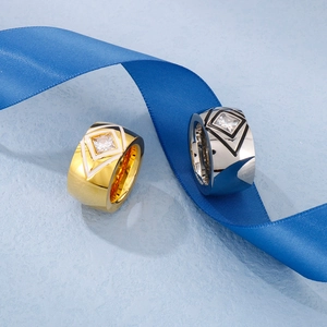 Macro detail of gold and silver stainless steel rings with square cubic zirconia and enamel