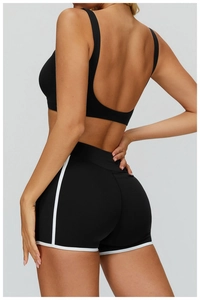 Detail of high-stretch black yoga shorts with white contrast binding for fitness training