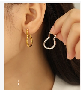 Detail shot of classic geometric hoop earrings in polished gold and silver finishes