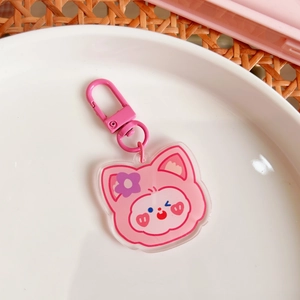 Detail of cute pink acrylic cat keychain with purple flower and matching lobster clasp