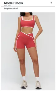 Close-up of raspberry red yoga set with white contrast piping and V-shape waistband
