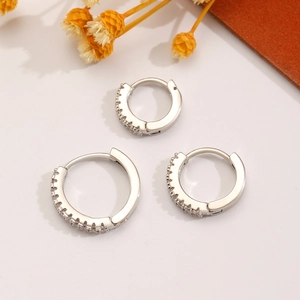 Three-piece set of silver huggie hoop earrings with sparkling cubic zirconia stones