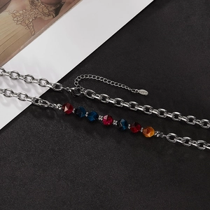 Detail of stainless steel chain necklace with colorful faceted natural stone beads