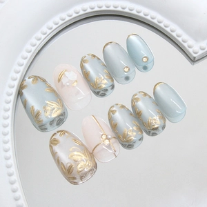 Green cat-eye press-on nails with 3D gold flowers and pearls in an elegant ins style