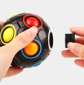 Macro detail of black 12-hole rainbow puzzle ball with colorful buttons and removable cap