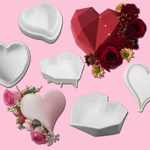 Macro detail of white silicone heart cake molds with finished floral desserts