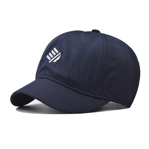Close-up of dark blue sports cap with honeycomb mesh texture and white embroidery
