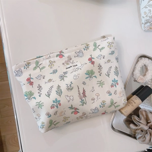 Detail of floral canvas makeup bag with animal prints and simple wish woven label