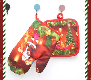 Close-up of Santa Claus themed heat resistant oven mitt and pot holder set with hanging loops