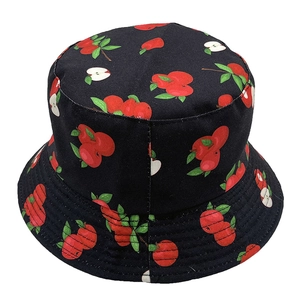 Close-up of black cotton fisherman hat featuring red apple and green leaf print