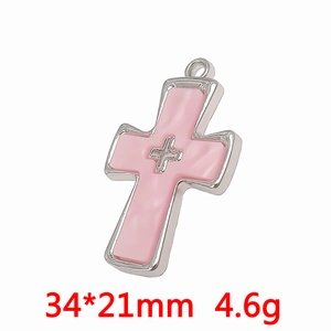 Detailed view of silver cross pendant with pink resin center and dimensions 34*21mm