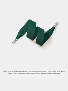 Close-up of 5cm wide green woven shoulder strap with leather ends and silver metal hooks