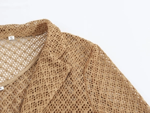 Detail shot of khaki crochet mesh fabric texture with a small size S neck label