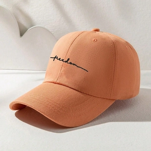 Pink cotton baseball cap featuring black freedom embroidery and a curved brim
