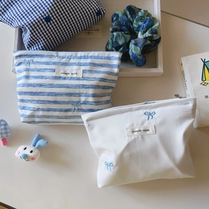 Blue and white striped cotton cosmetic bag with bow embroidery and zipper closure