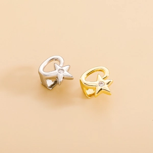 Detailed view of gold and silver star-shaped tooth caps with inlaid sparkling zircons
