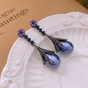 Vintage floral drop earrings with blue pearl fringe and purple flower details