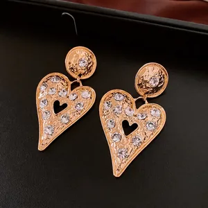 Vintage gold heart drop earrings with hammer texture and sparkling crystal rhinestones