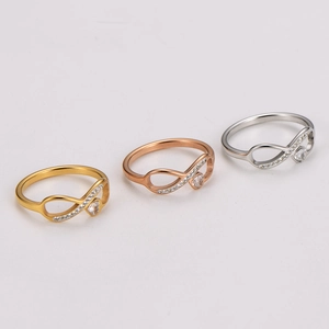 Infinity heart rings set in gold rose gold and silver finishes with crystal accents