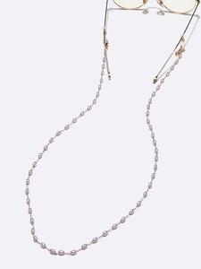 Detail of lavender rice pearls and gold chain link eyeglass strap with rubber loops