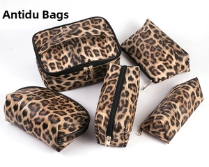 Detailed set of leopard print makeup bags including a large case and four zipper pouches