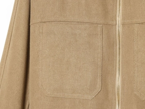 Detail of khaki twill jacket showing chest pocket and smooth metal zipper closure