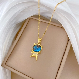 Starry astronaut pendant necklace in gold with blue stones and zircon stones on silk