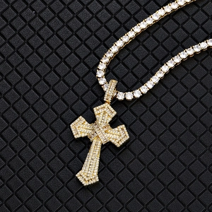 Detailed close-up of hip-hop cross pendant with mixed zircon stones on a gold chain