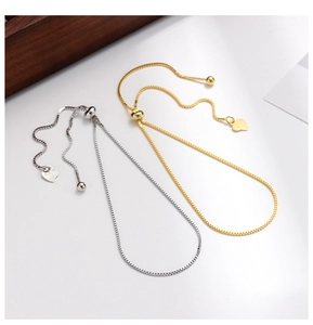 Detail of adjustable S925 sterling silver box chain bracelets with heart pendants
