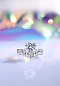 Macro shot of 2ct Moissanite crown ring set with silver band and polished V-shaped guard