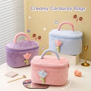 Quilted corduroy cosmetic bag with floral applique in purple, pink, and blue colors