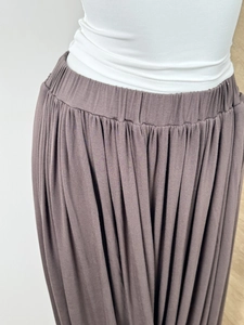 Detail view of high-waist elastic band and pleating on dark brown Chinese style skirt