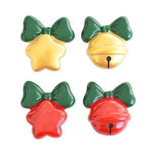Festive resin Christmas bow and bell pendants for DIY crafts on a white background