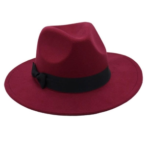 Close-up of deep red wool fedora hat featuring a black decorative ribbon and bow detail