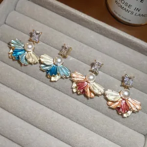 Elegant gold-plated fan-shaped pearl earrings with enamel petals and shiny cubic zirconia